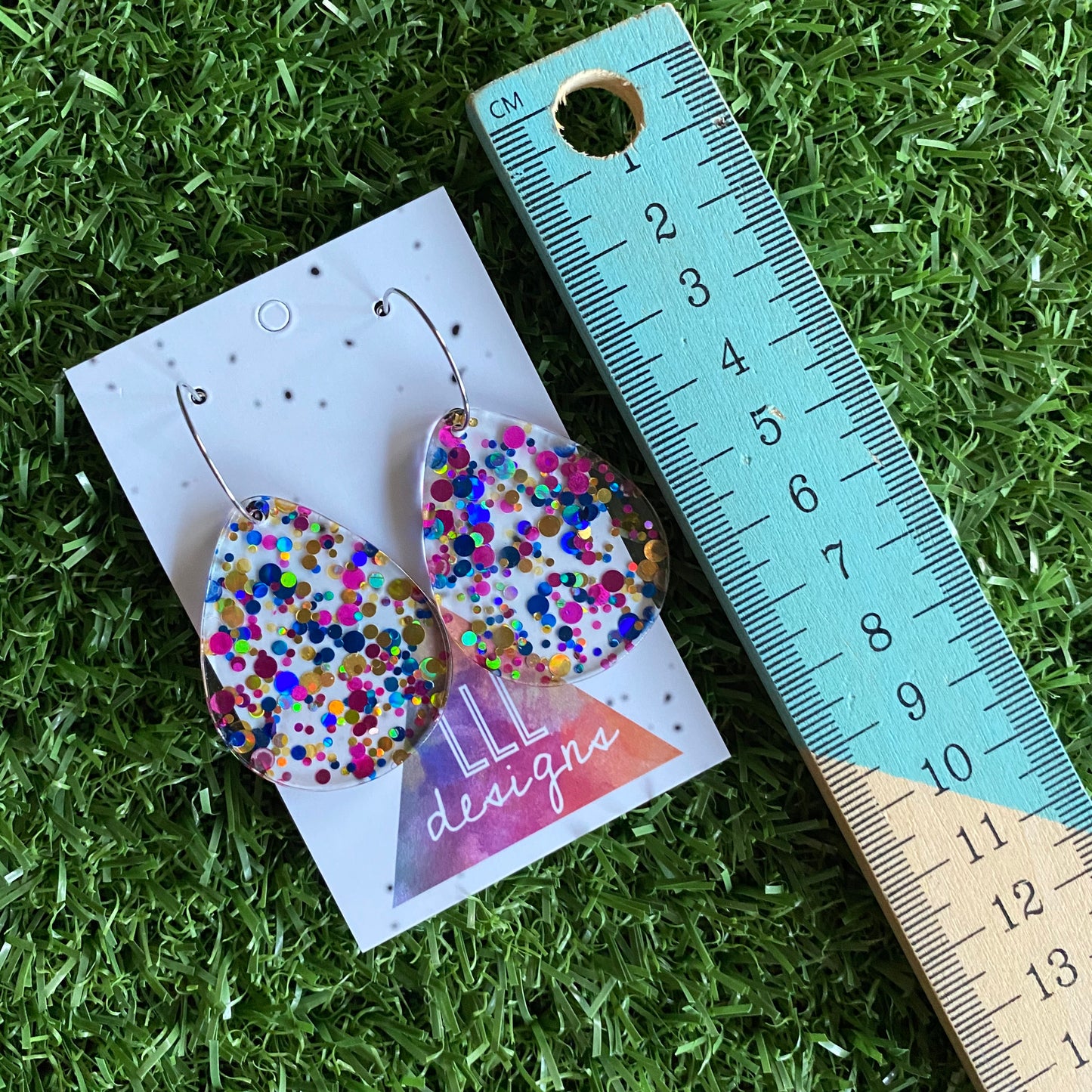 Stunning Clear Tear Drops featuring Polka Dot Confetti Scattered Throughout. Creating a beautiful visual effect. (Blue/Pink/Gold).