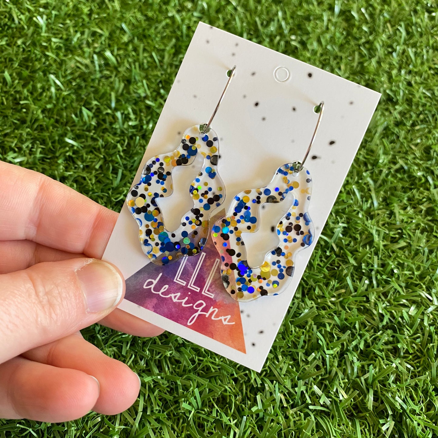 Stunning Clear Wiggle Jiggle Drops featuring Polka Dot Confetti Scattered Throughout. Creating a beautiful visual effect. (Gold/Black/Blue).