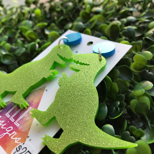 Terrific Trex Statement Dangle Earrings. Jumbo Dino Dangles will always Brighten your day! Get your Groove on with this Glittery Guys!!