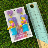 Lizzy Brick Character With Magical Hair and Super Cute Face Details Dangle Earrings - Featuring Purple Glitter Heart Shaped Tops!