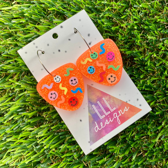 Resin Earrings - Glitter Neon Orange Guitar Pick Hoops Featuring Hand Placed Rainbow Smiley Faces and Squiggles!