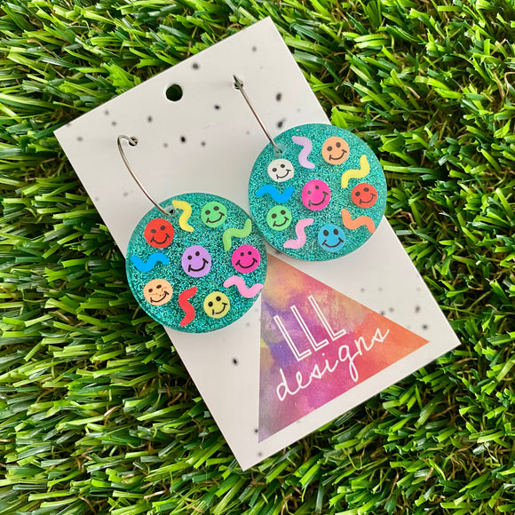 Resin Earrings - Glitter Teal Circle Hoops Featuring Hand Placed Rainbow Smiley Faces and Squiggles!