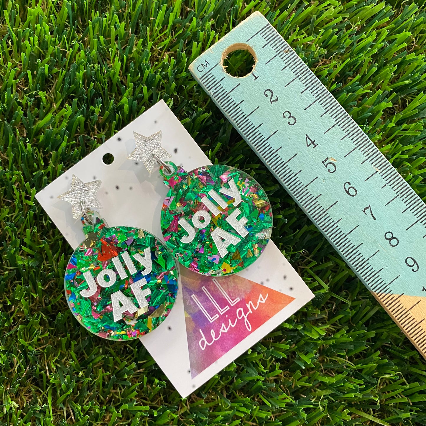 Jolly AF Statement Dangle Earrings in Green Tone and Rainbow Glitter Featuring Silver Star Tops.