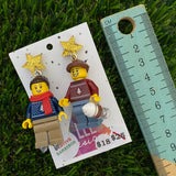Christmas Couple Brick Earrings- Seasonal Couple with Ice Skates and Hot Chocolate Dangle Earrings, Featuring Festive Gold Star Tops.