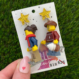 Christmas Couple Brick Earrings- Seasonal Couple with Ice Skates and Hot Chocolate Dangle Earrings, Featuring Festive Gold Star Tops.
