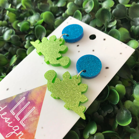 Stegosaurus Statement Dangle Earrings. Glitter Dino Dangles will always Brighten your day! Get your Groove on with this Glittery Guys!!