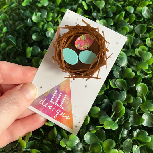 Easter Brooch. Birds Nest Brooch - Featuring 2 Matte Pastel Mint and 1 Colourful Speckled Eggs, set in a nest made of 3 layers of intricately cut acrylic.