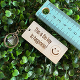 "This is the key to happiness! :)" Quirky Timber Keyring - Laser Cut & Etched on Timber with Silvertone Hardware finished with a LLL Logo Tag.