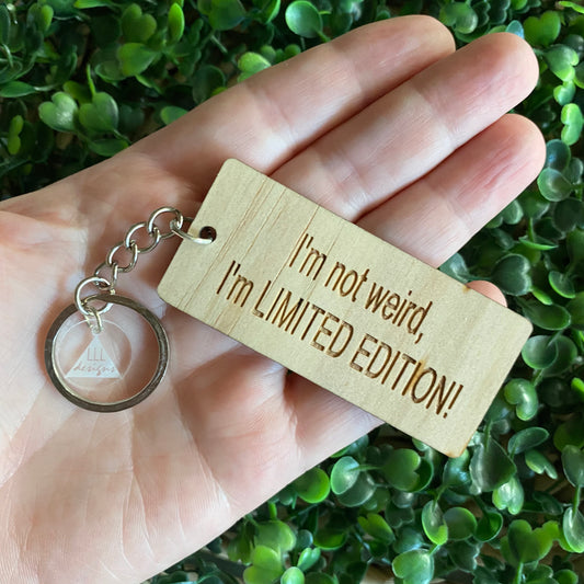 "I'm not weird, I'm LIMITED EDITION!" Quirky Timber Keyring - Laser Cut & Etched on Timber with Silvertone Hardware finished with a LLL Logo Tag.