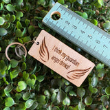 "I think my guardian angel drinks!" Quirky Timber Keyring - Laser Cut & Etched on Timber with Silvertone Hardware finished with a LLL Logo Tag.