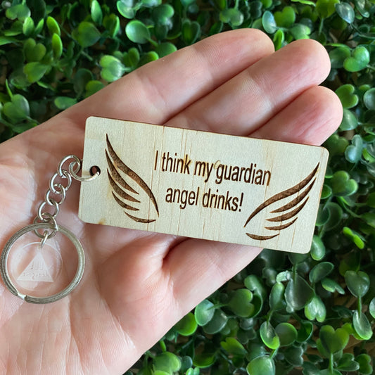"I think my guardian angel drinks!" Quirky Timber Keyring - Laser Cut & Etched on Timber with Silvertone Hardware finished with a LLL Logo Tag.