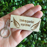 "I think my guardian angel drinks!" Quirky Timber Keyring - Laser Cut & Etched on Timber with Silvertone Hardware finished with a LLL Logo Tag.