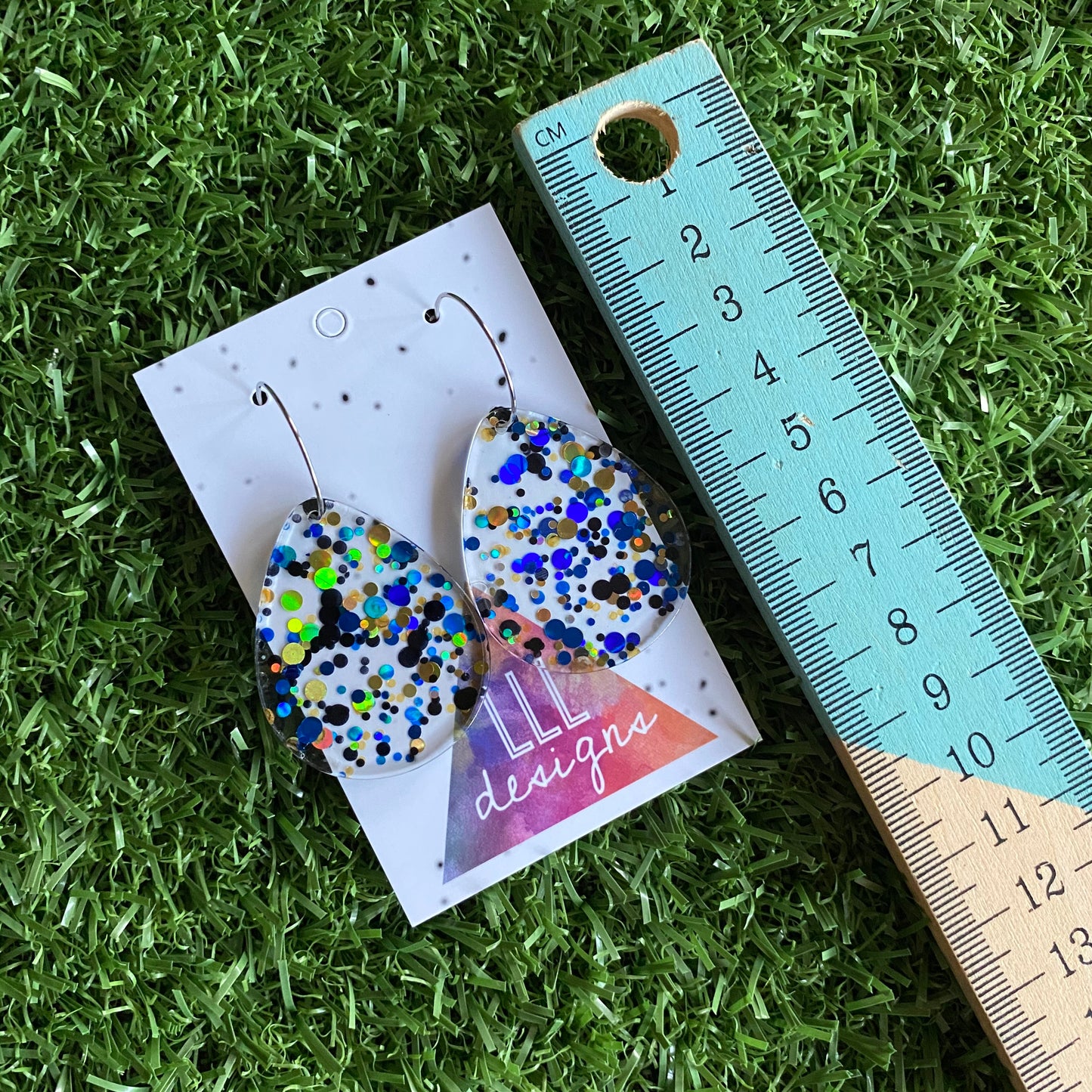 Stunning Clear Tear Drops featuring Polka Dot Confetti Scattered Throughout. Creating a beautiful visual effect. (Blue/Black/Gold).