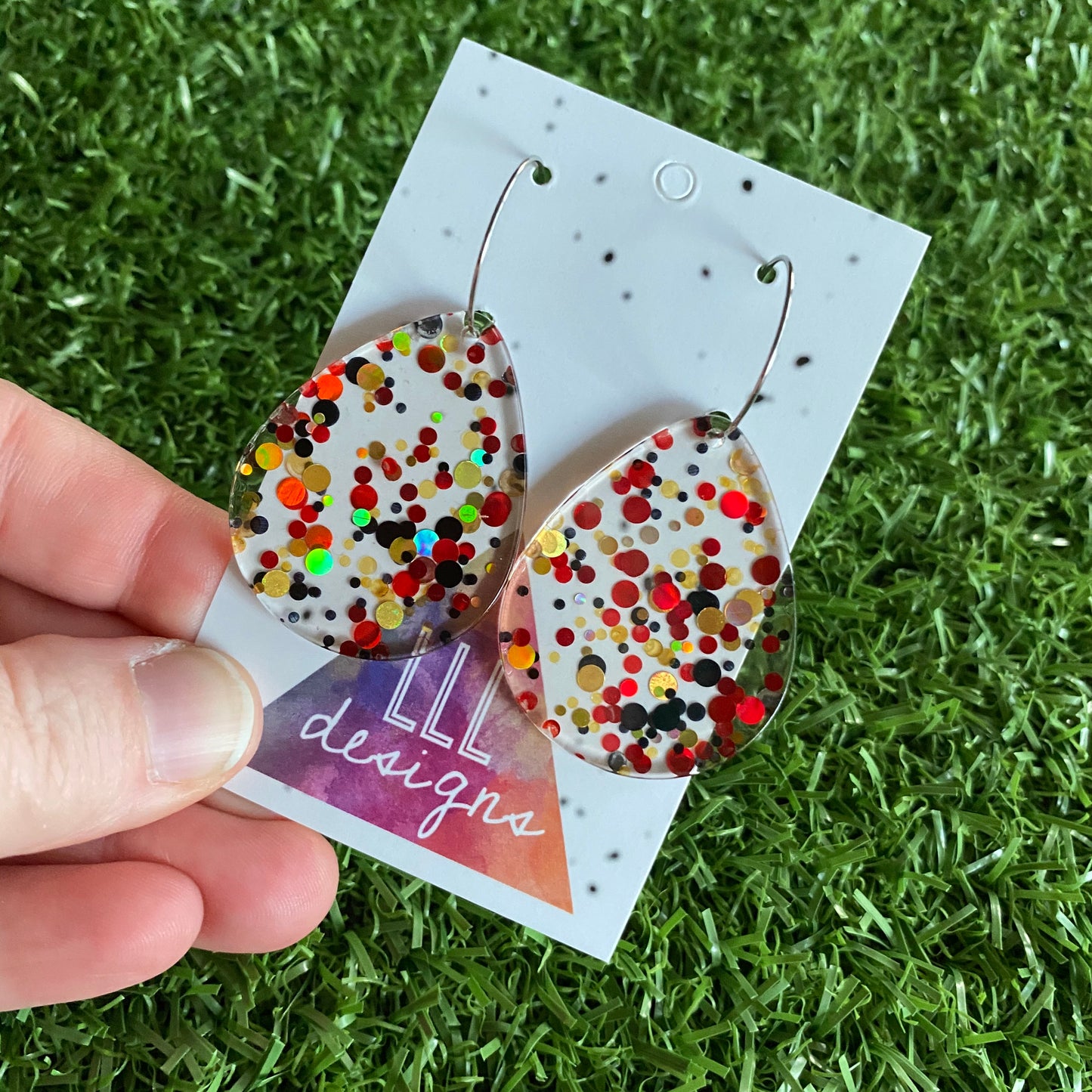 Stunning Clear Tear Drops featuring Polka Dot Confetti Scattered Throughout. Creating a beautiful visual effect. (Gold/Red/Black).