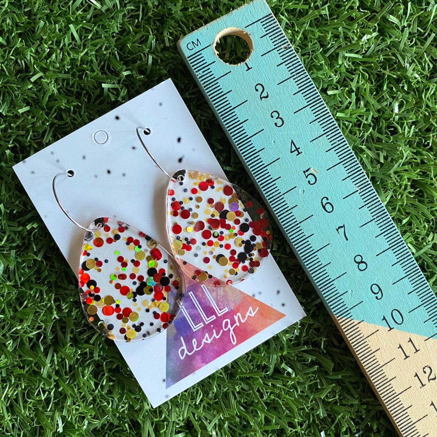 Stunning Clear Tear Drops featuring Polka Dot Confetti Scattered Throughout. Creating a beautiful visual effect. (Gold/Red/Black).