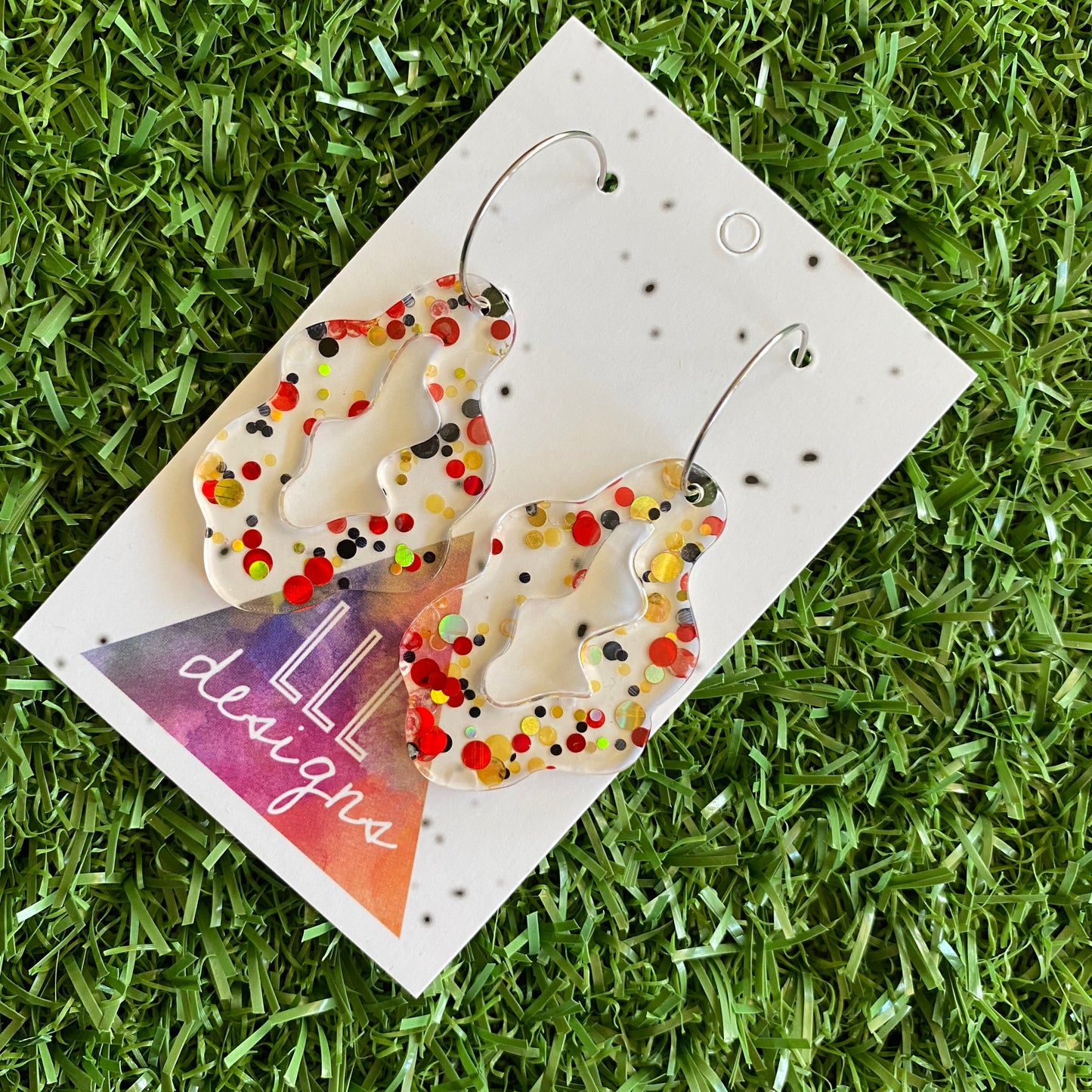 Stunning Clear Wiggle Jiggle Drops featuring Polka Dot Confetti Scattered Throughout. Creating a beautiful visual effect. (Gold/Red/Black).