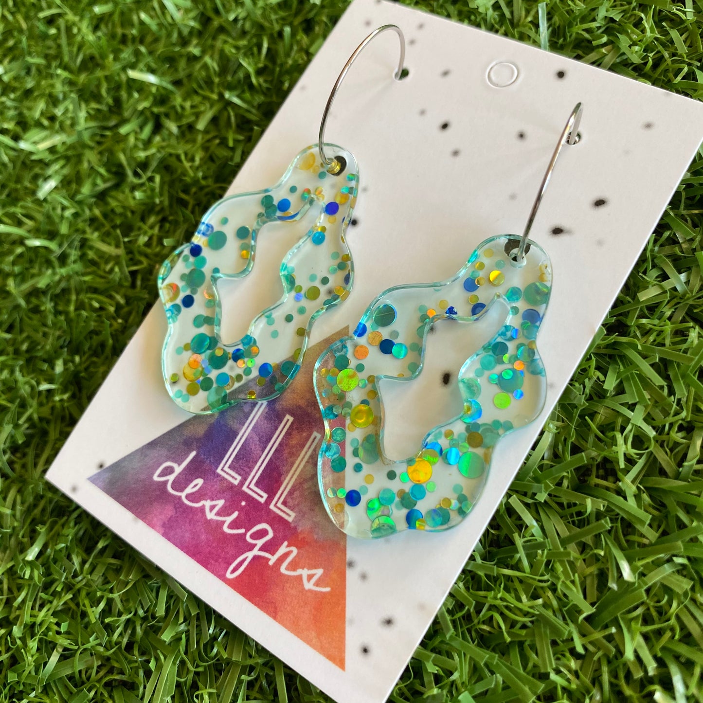 Stunning Clear Wiggle Jiggle Drops featuring Polka Dot Confetti Scattered Throughout. Creating a beautiful visual effect. (Gold/Aqua/Blue).