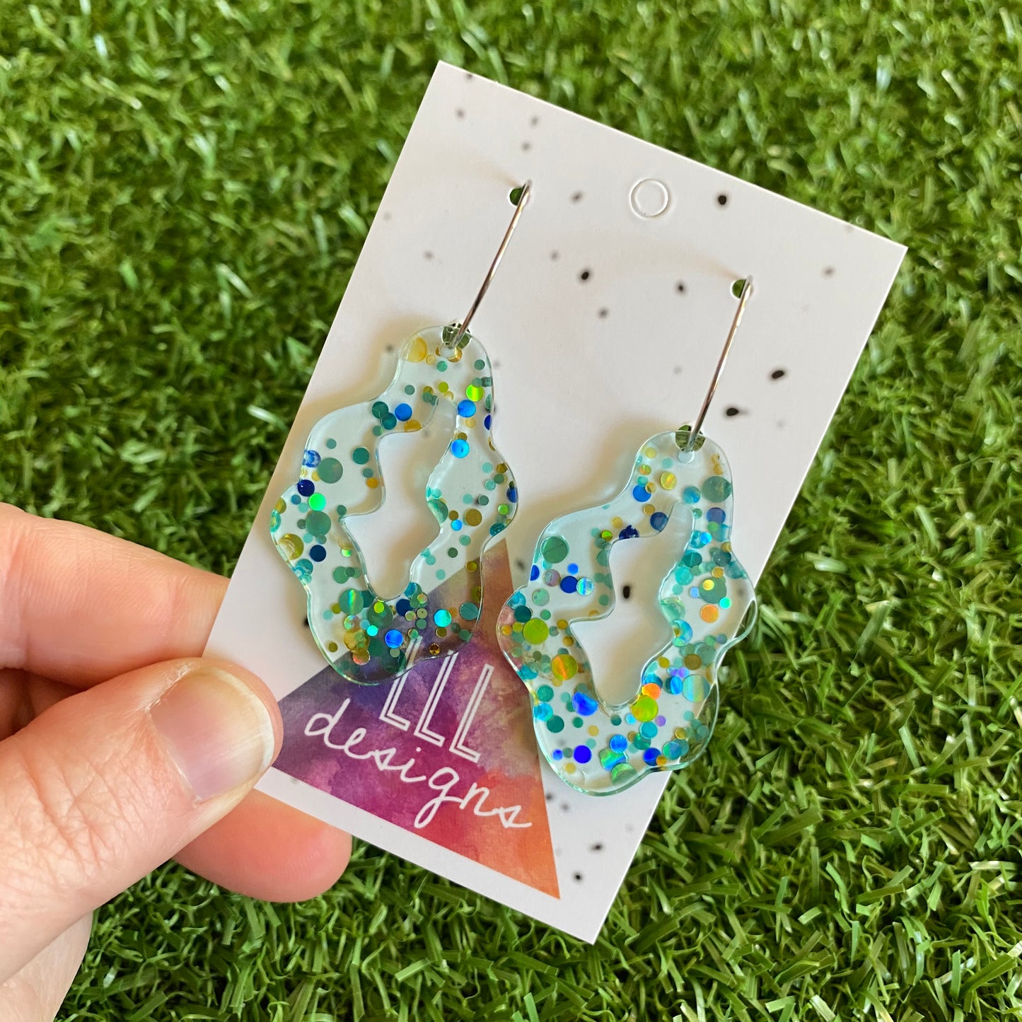 Stunning Clear Wiggle Jiggle Drops featuring Polka Dot Confetti Scattered Throughout. Creating a beautiful visual effect. (Gold/Aqua/Blue).