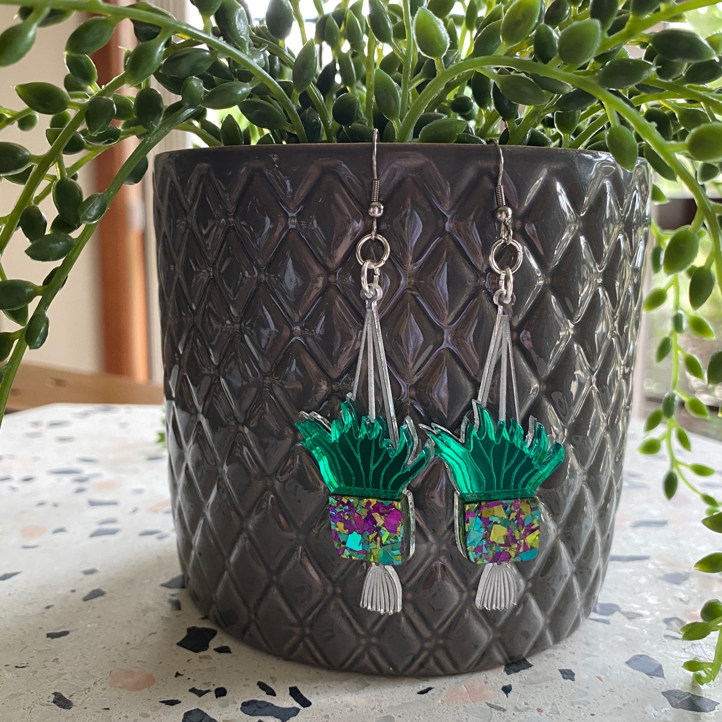 Hanging Planter Dangle Earrings. Featuring Stunning Purple and Green Holographic Planters hanging from Surgical Stainless Steel Hooks.